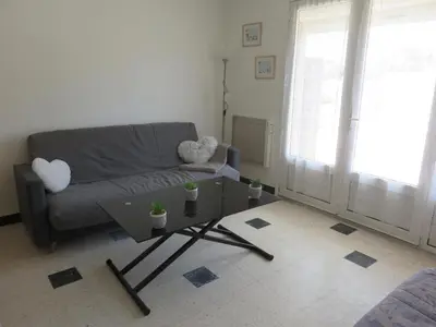 a living room with a couch and a coffee table at Le Géranium in Port-la-Nouvelle