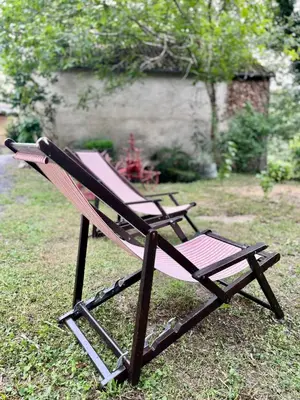 two lawn chairs sitting on the grass in a yard at Parenthèse en Forêt - Gîte Baliveau, Sidobre in Le Bez