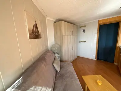 a living room with a couch and a table at Studio vue mer et plage in Gruissan