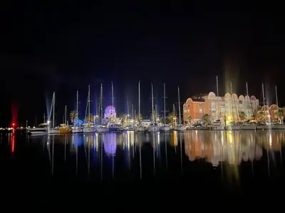 a marina at night with boats in the water at Studio vue mer et plage in Gruissan