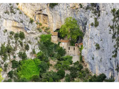 a monastery built into the side of a mountain at Roulotte in Bugarach