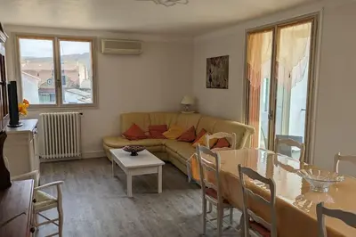 a living room with a couch and a table at La Pinède in Espéraza