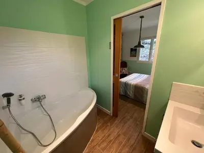 a bathroom with a bath tub and a sink at Villa contemporaine avec piscine in Montredon