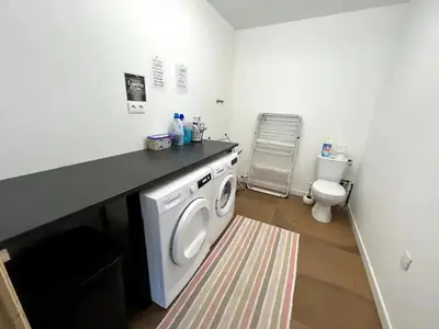 a washing machine in a bathroom with a toilet at Villa contemporaine avec piscine in Montredon