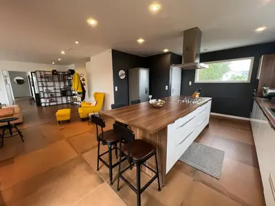 a kitchen with a wooden counter top in a room at Villa contemporaine avec piscine in Montredon
