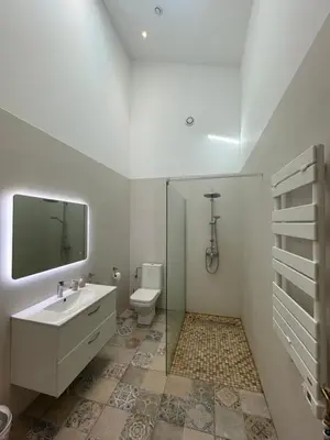 a white bathroom with a sink and a toilet at Appartement standing proche plage in Fitou