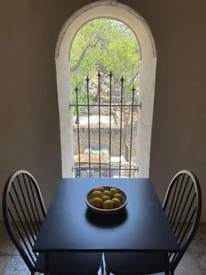 a blue table with a bowl of fruit on it at Appartement standing proche plage in Fitou
