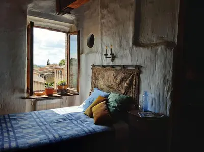 a bedroom with a bed and a window at Gîte Dűrer in Fanjeaux