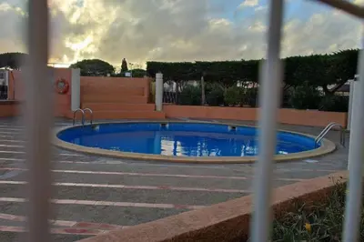 a swimming pool in the middle of a parking lot at Superbe Studio avec vue sur le port de Gruissan, piscine, parking in Gruissan