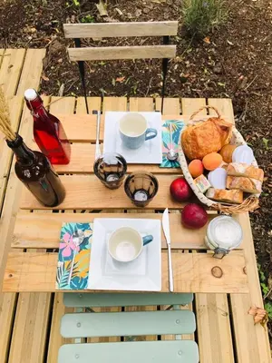 a picnic table with food and a basket of food at Ô cocon del Lauragués in Ricaud