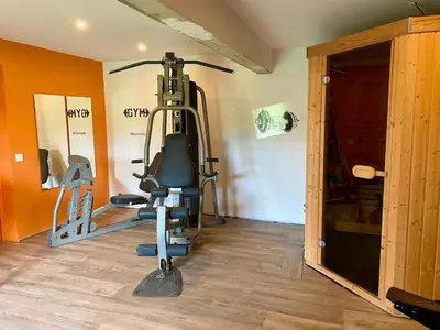 a room with a gym with a treadmill at Séjour confort et nature in Saint-Amans-Valtoret