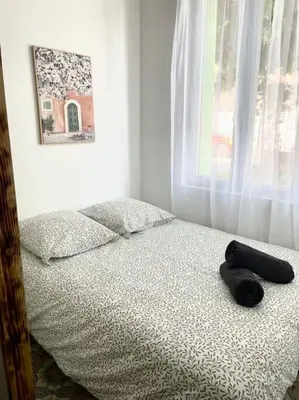 a bed with a black remote control sitting on it at Le Briguiboul l Rez-de-chaussée l Stationnement gratuit in Castres