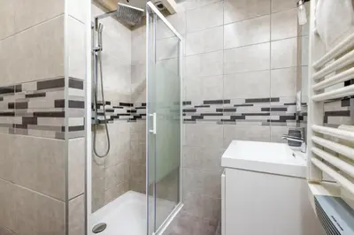 a bathroom with a shower and a toilet and a sink at L'atelier De La Cite - Parking Gratuit Sécurisé in Carcassonne