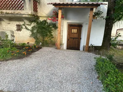 a house with a door and a gravel driveway at Eden de Roques in Castres
