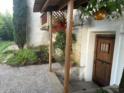 a house with a wooden door and a balcony at Eden de Roques in Castres