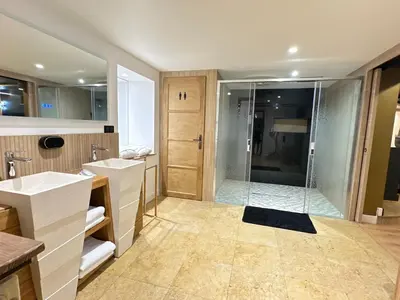 a bathroom with two sinks and a shower at Eden de Roques in Castres