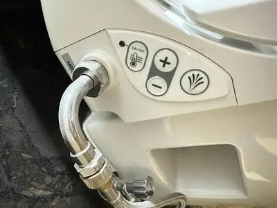 a close up of a toilet with stickers on it at Eden de Roques in Castres