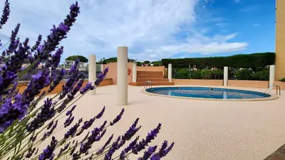 a garden with a pool and purple flowers at - L'Horizon Bleu - Cocon romantique avec vue mer panoramique in Gruissan