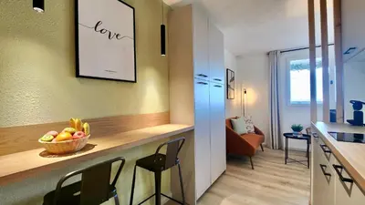 a kitchen with a counter with a bowl of fruit on it at - L'Horizon Bleu - Cocon romantique avec vue mer panoramique in Gruissan