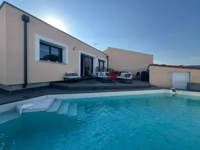 a swimming pool in front of a house at La Villa des Cistes au calme vue Étangs in Narbonne