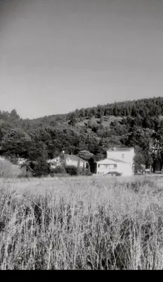 a black and white photo of a house in a field at Le Sanglier Noir 14 in Villeneuve-les-Corbières