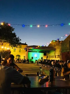 a group of people sitting at a table at night at Le Sanglier Noir 14 in Villeneuve-les-Corbières