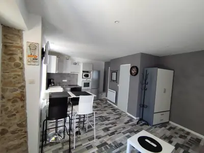 a kitchen with white appliances and black counter tops at franck in Marcorignan