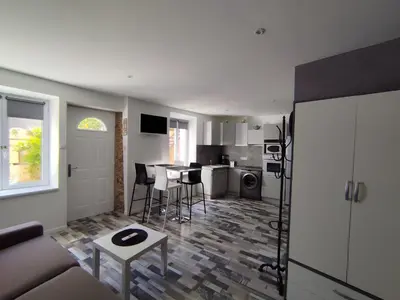 a living room with a couch and a kitchen at franck in Marcorignan
