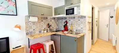 a small kitchen with a sink and a microwave at Perrutel - entre Bastide et cité in Carcassonne