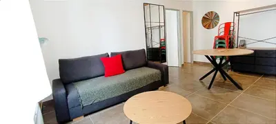 a living room with a couch and a table at Perrutel - entre Bastide et cité in Carcassonne