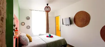 a small room with a bed and a window at Perrutel - entre Bastide et cité in Carcassonne