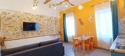 a living room with a couch and a table at Perrutel - entre Bastide et cité in Carcassonne