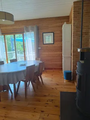 a dining room with a table and chairs at Maison chaleureuse en Ariège in Roquefort-les-Cascades