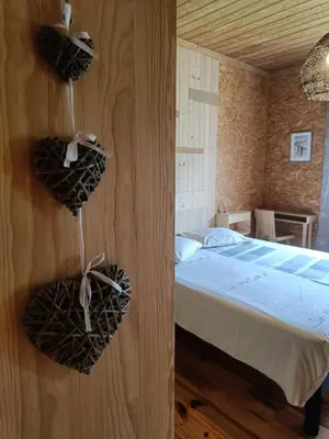 a bedroom with a bed with baskets on the wall at Maison chaleureuse en Ariège in Roquefort-les-Cascades