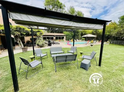 a group of chairs and a table in a yard at Domaine 15 pers, Piscine, Pétanque, Canal du midi in Carcassonne