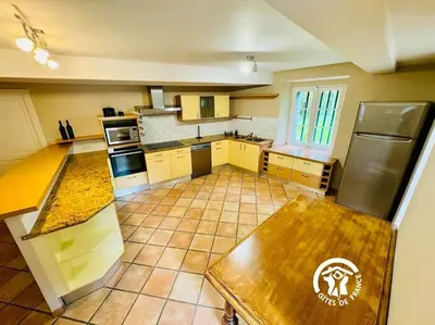 an aerial view of a kitchen with yellow cabinets at Domaine 15 pers, Piscine, Pétanque, Canal du midi in Carcassonne