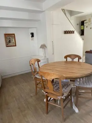a dining room with a wooden table and chairs at Charmante maison de ville in Mirepoix