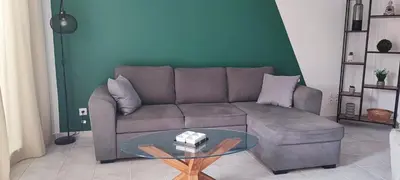 a living room with a couch and a glass table at Charmante maison in Carcassonne