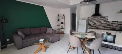 a living room with a couch and a table at Charmante maison in Carcassonne