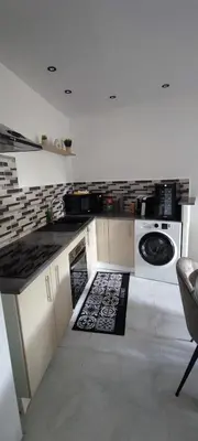 a kitchen with a stove and a dishwasher at Charmante maison in Carcassonne