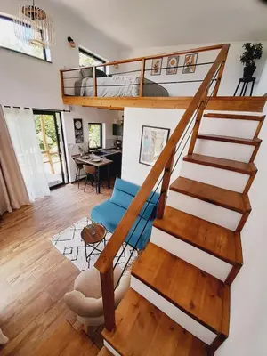 a spiral staircase in a room with a living room at Cozy Tiny House plus SPA - à Pereille d'en Haut in Péreille