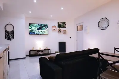 a living room with a couch and a table at Le Cocon Capestanais in Capestang