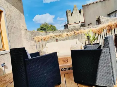 a balcony with three chairs on a roof at Le Rendez Vous - 4 étoiles - parking gratuit in Carcassonne