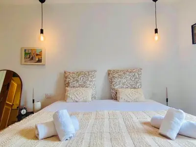 a bedroom with a large white bed with two pillows at Le Rendez Vous - 4 étoiles - parking gratuit in Carcassonne