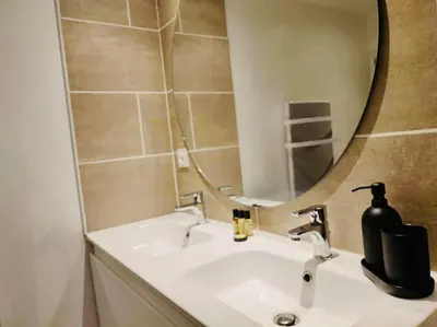 a bathroom with a sink and a mirror at Le Rendez Vous - 4 étoiles - parking gratuit in Carcassonne