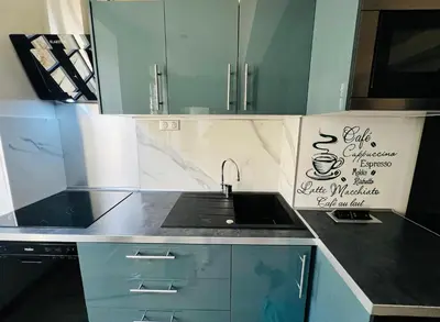 a kitchen with a sink and a sign on the wall at Good vibes in Limoux