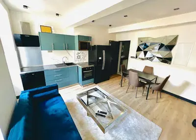 a kitchen with a couch and a table in a room at Good vibes in Limoux
