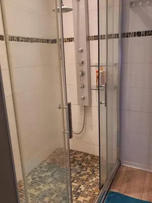 a shower with a glass door in a bathroom at Chambre d'hote la passerelle in Mazamet