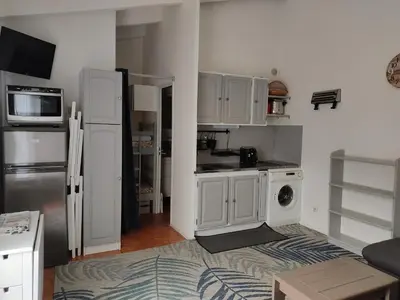 a kitchen with white cabinets and a refrigerator at Charmant T3 climatisé avec terrasse, proche plage & parking privé - 4/6 pers, Gruissan - FR-1-796-7 in Gruissan