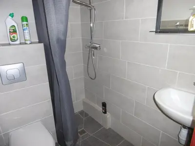 a bathroom with a shower with a toilet and a sink at T2 cabine climatisé avec piscine, parking privé, proche port et commerces, idéal 4-5 pers. - FR-1-796-9 in Gruissan